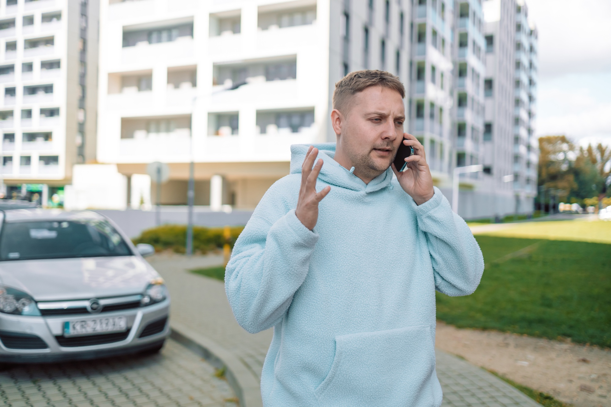 Caucasian confused man disappointed 30s guy millennial male worried stressed car driver near modern